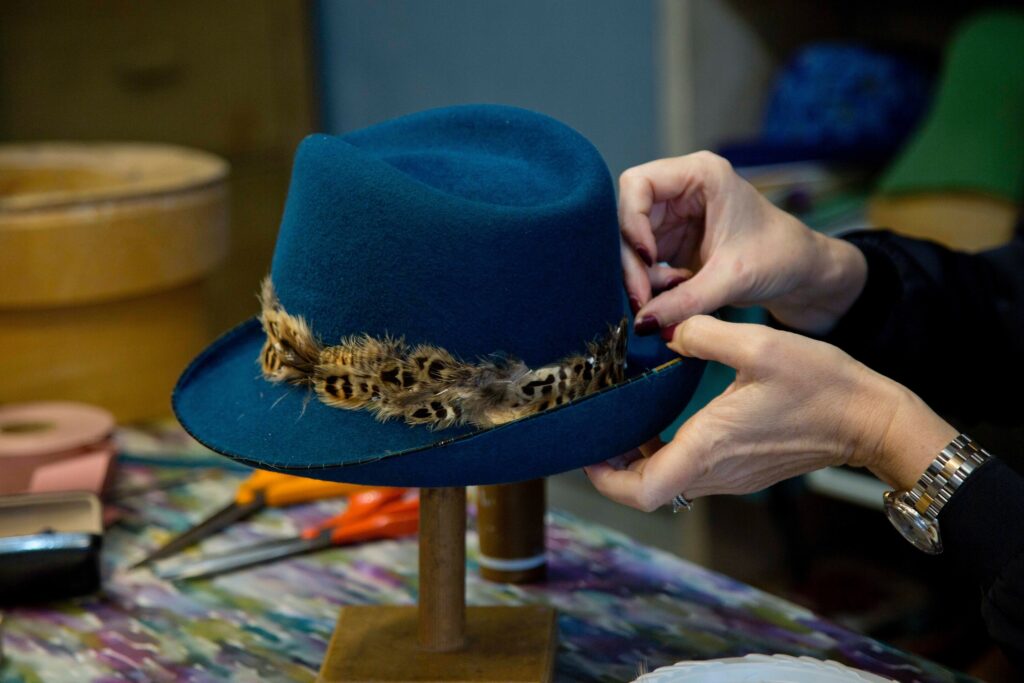 Louise Pocock adding accessories to hat